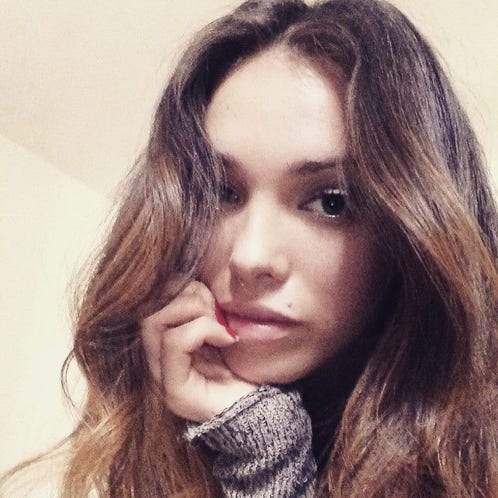 Female ethnic patient with open mouth in dental clinic